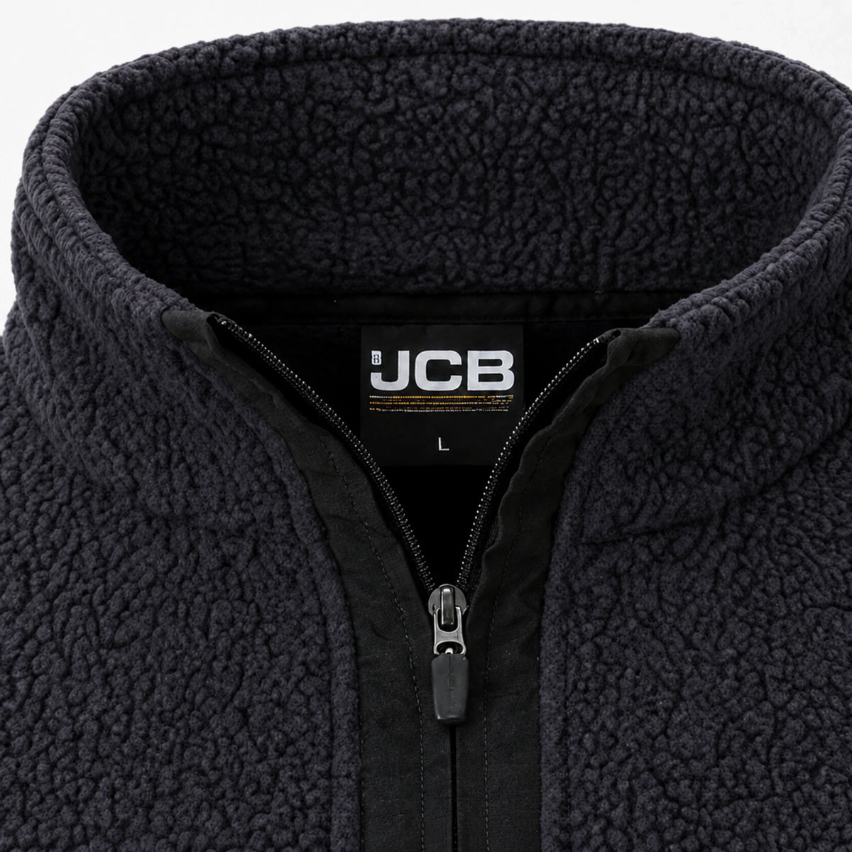 Zbliżenie na kołnierz i zamek 1/4 polaru JCB Borg z logo JCB na zamku